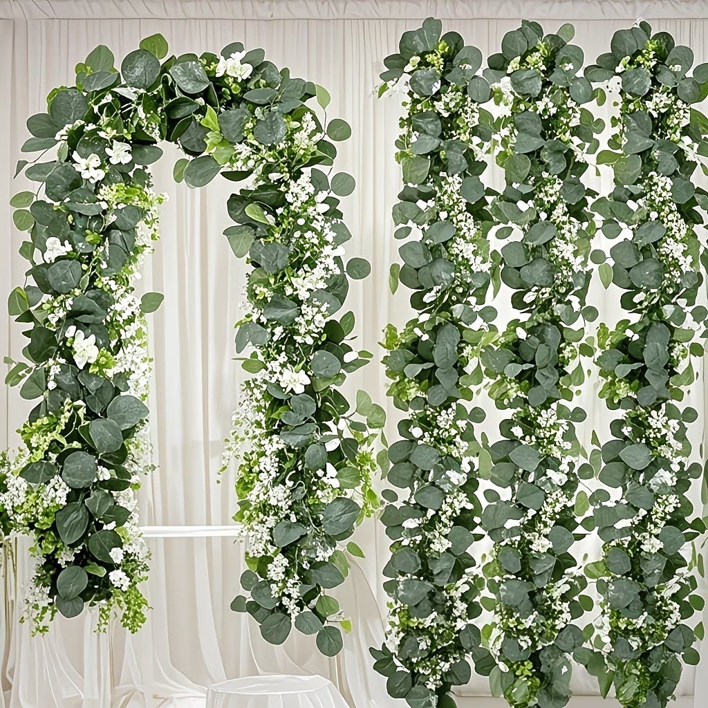 Conjunto de 2/4 guirlandas de eucalipto, com comprimento total de 141,73 polegadas (360 cm), adornadas com flores brancas, folhas prateadas e folhagens realistas, ideais para decoração de casamentos e de 2026 por $16.99 –P1