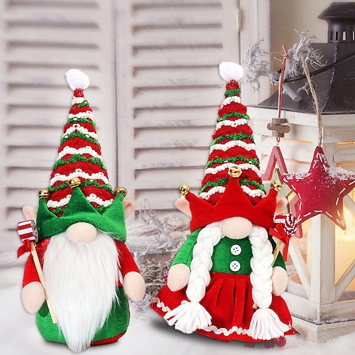 

A Couple Of Elf Dolls With A Santa Claus Doll And A Faceless Doll With Christmas Decorations