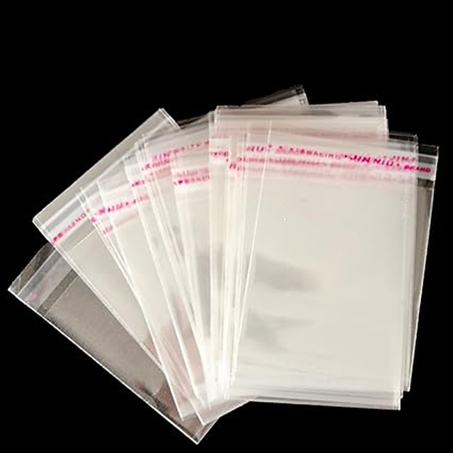  100 kpl läpinäkyviä sellofaanimuovipusseja opp-kotelo, jossa on liimasuljin