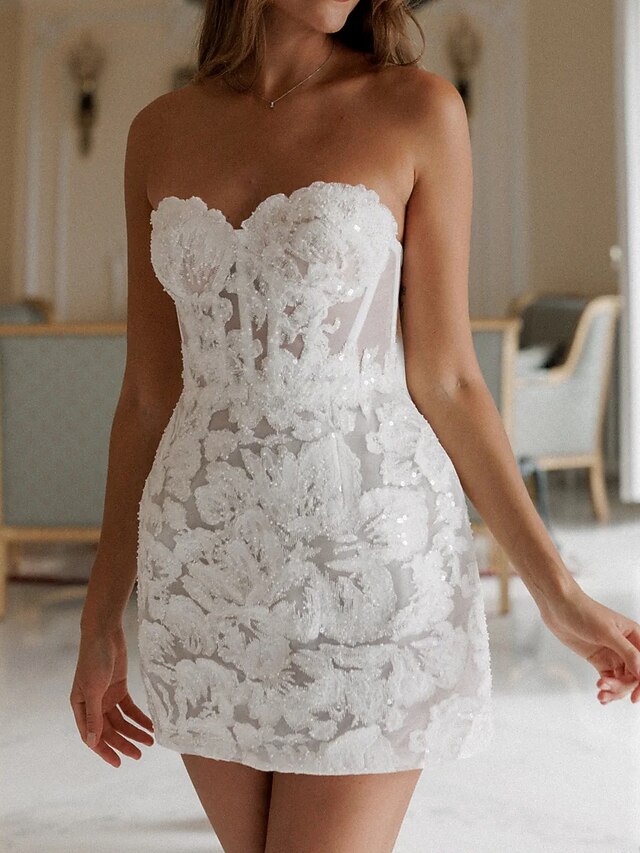 White strapless short - style wedding dress. Ideal for outdoor weddings and intimate wedding parties this mini wedding dress.4