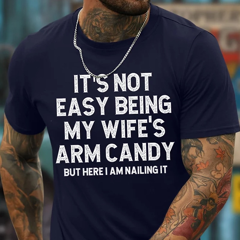 Men's Graphic T-Shirt: "It's Not Easy Being My Wife's Arm Candy But Here I Am Nailing It" - Funny Family Humor Short Sleeve Top2