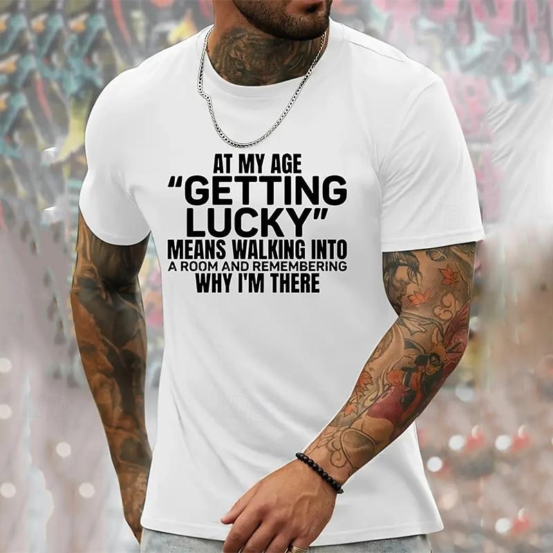 Humorous Men's Graphic T-Shirt featuring 'At My Age Getting Lucky Means Remembering Why I'm There' Quote, Funny Aging Lifestyle Short Sleeve