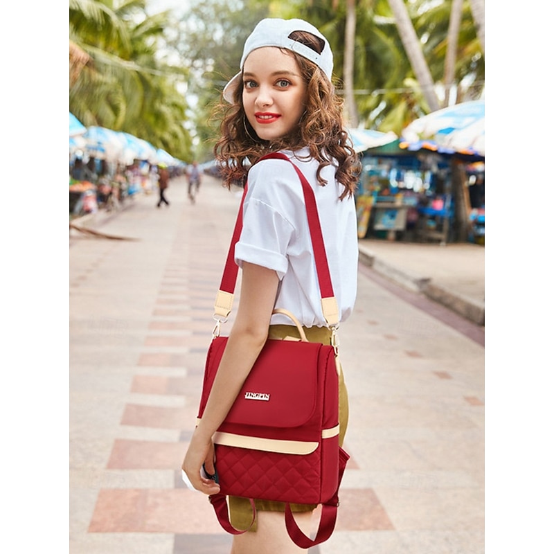 Women's Quilted Red Backpack with Pom Pom Charm – Stylish and Practical Bag with Adjustable Straps and Beige Accents
