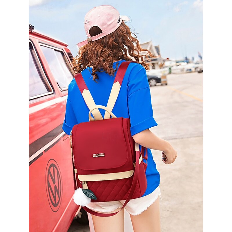 Women's Quilted Red Backpack with Pom Pom Charm – Stylish and Practical Bag with Adjustable Straps and Beige Accents2