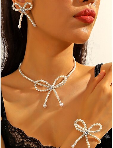  Elegante conjunto de joyas con lazo de perlas para mujer: collar, aretes y pulsera con detalles dorados para bodas y eventos formales.