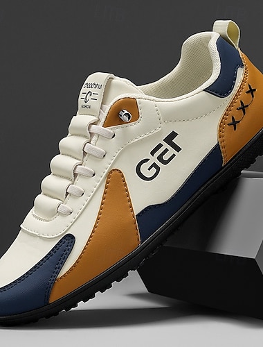  Baskets de golf noires et beiges pour hommes, sportives et confortables, idéales pour les parcours de golf et les sorties actives.