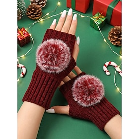 Women's polyester fingerless knitted gloves, designed for winter warmth and wrist protection, and accented with a faux-fur pom-pom. Available in multiple color